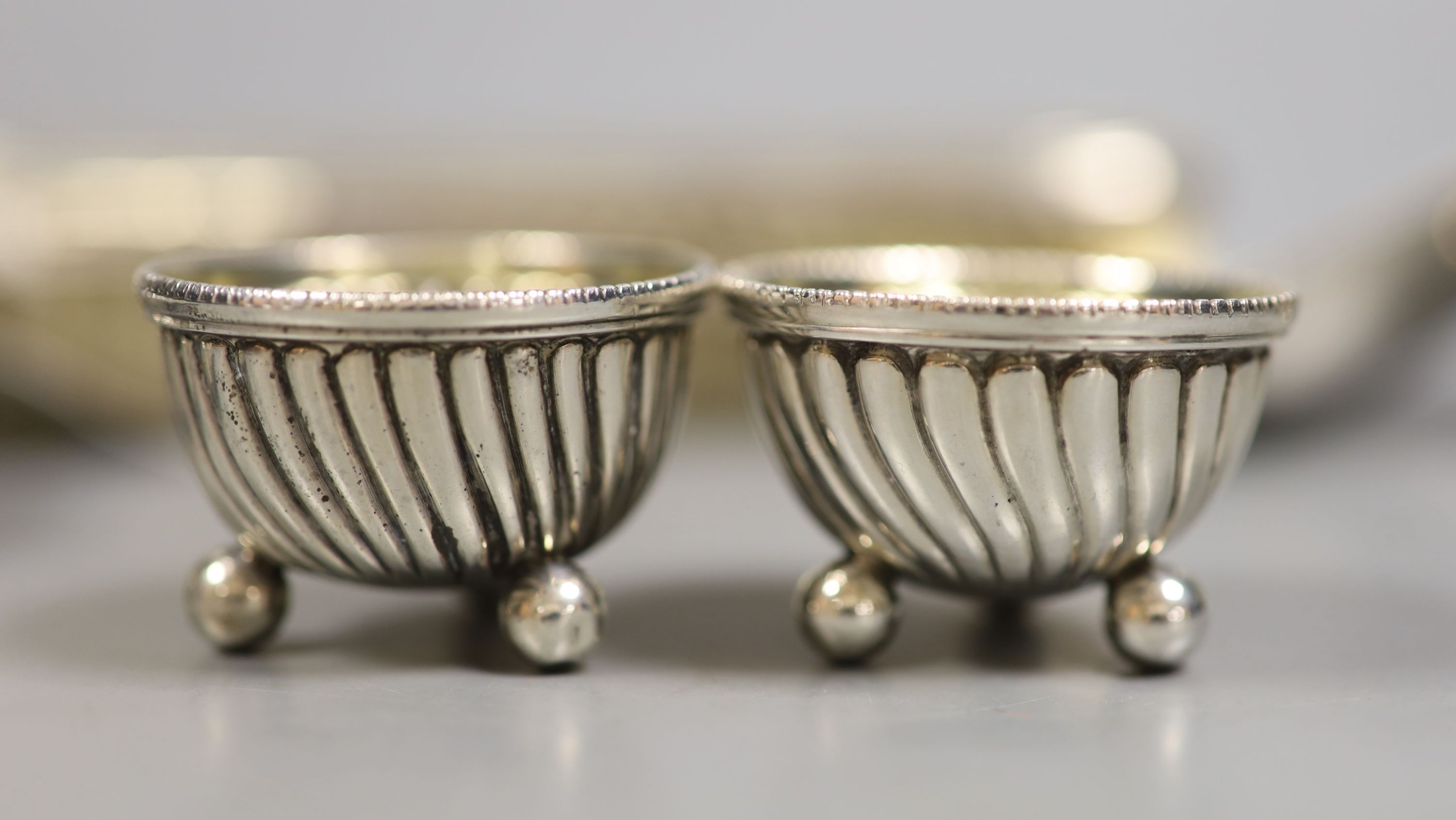 A small group of silver and white metal items including a William IV mounted coaster, London, 1830, 12.9cm, a small silver bowl and pill, box, a Georgian caddy spoon, two Austro-Hungarian salts, and 800 egg cup, a Dutch